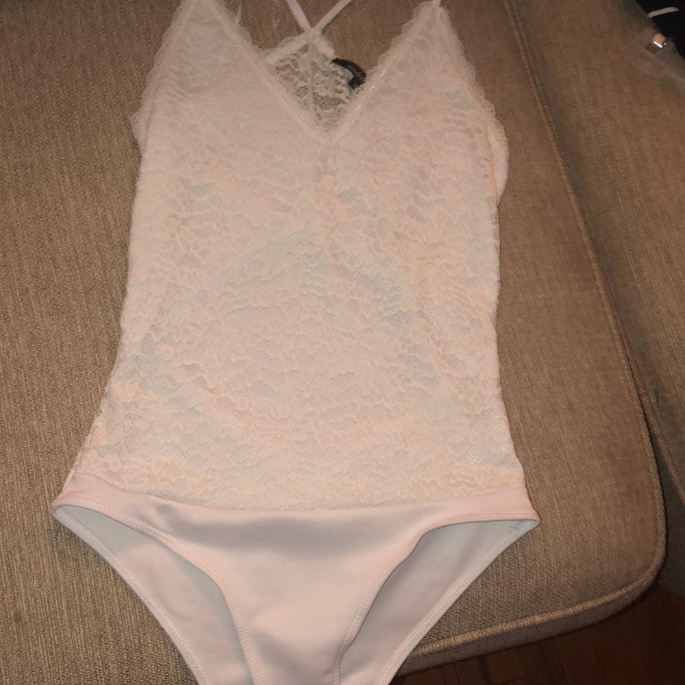Never worn.white lace body suit.also lingerie